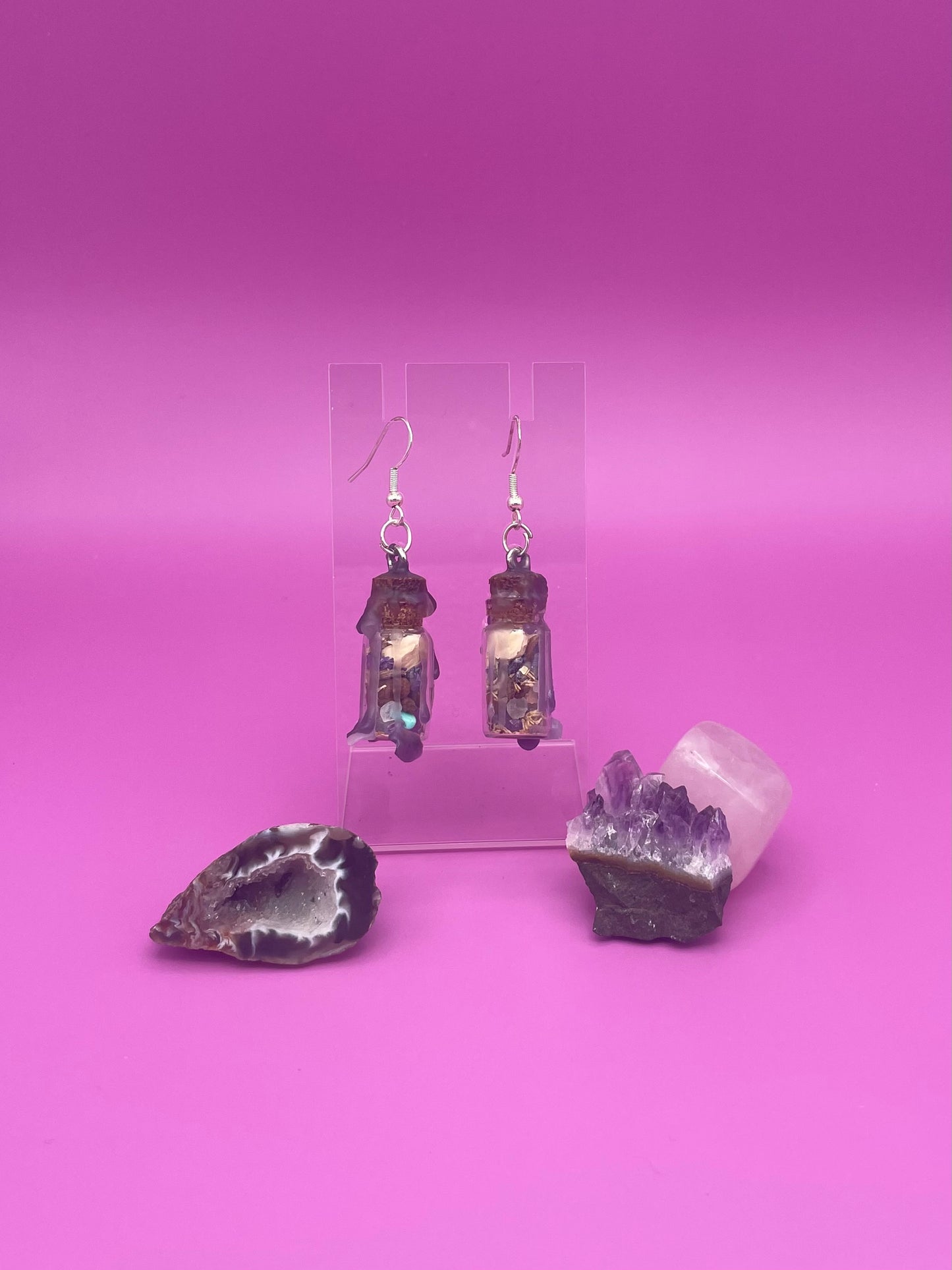 Peace spell jar earrings on clear stand
