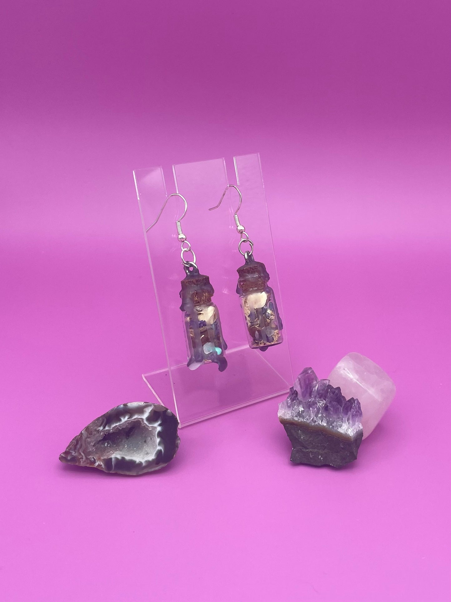 Peace spell jar earrings on clear stand