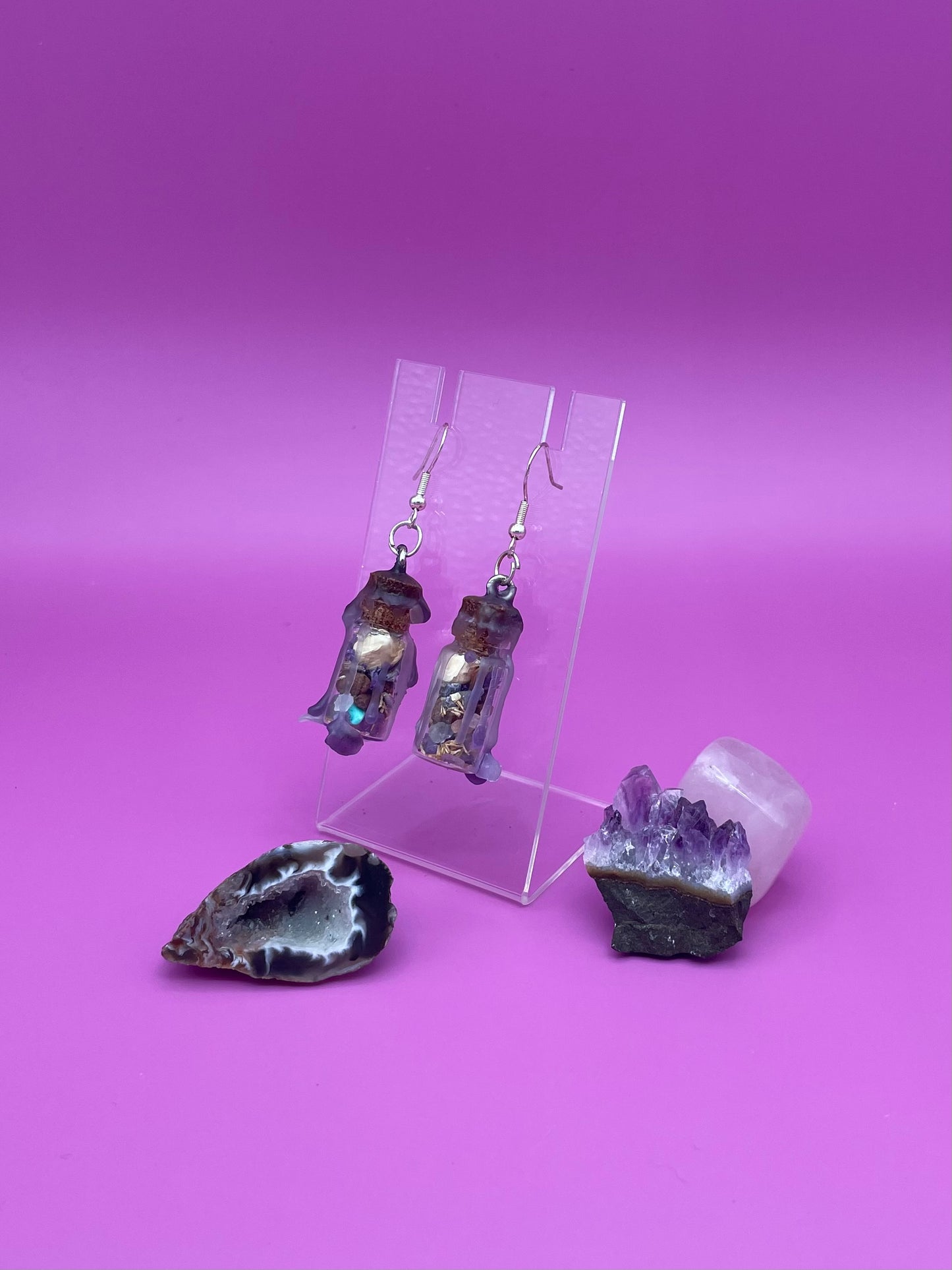 Peace spell jar earrings on clear stand