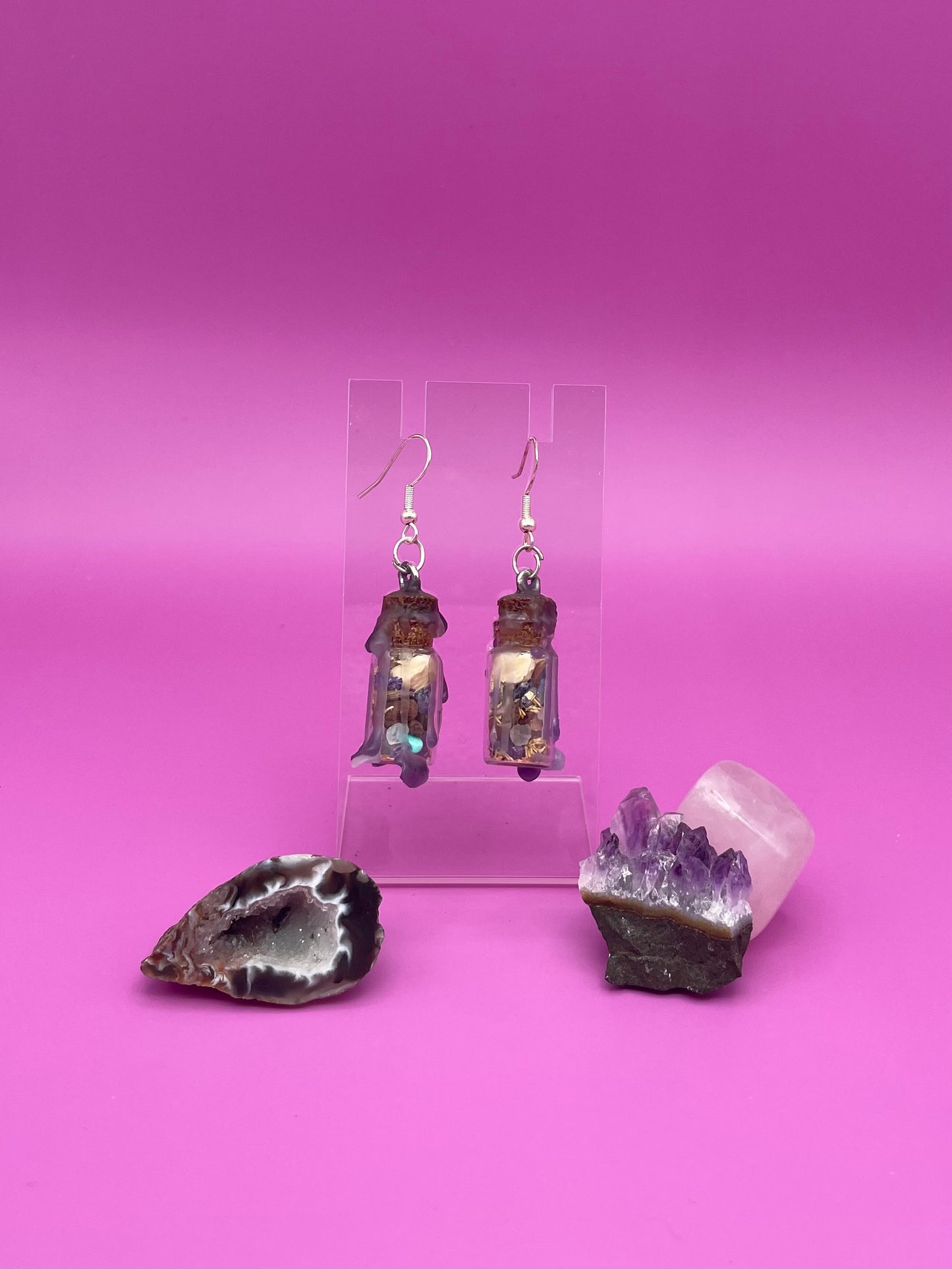 Peace spell jar earrings on clear stand