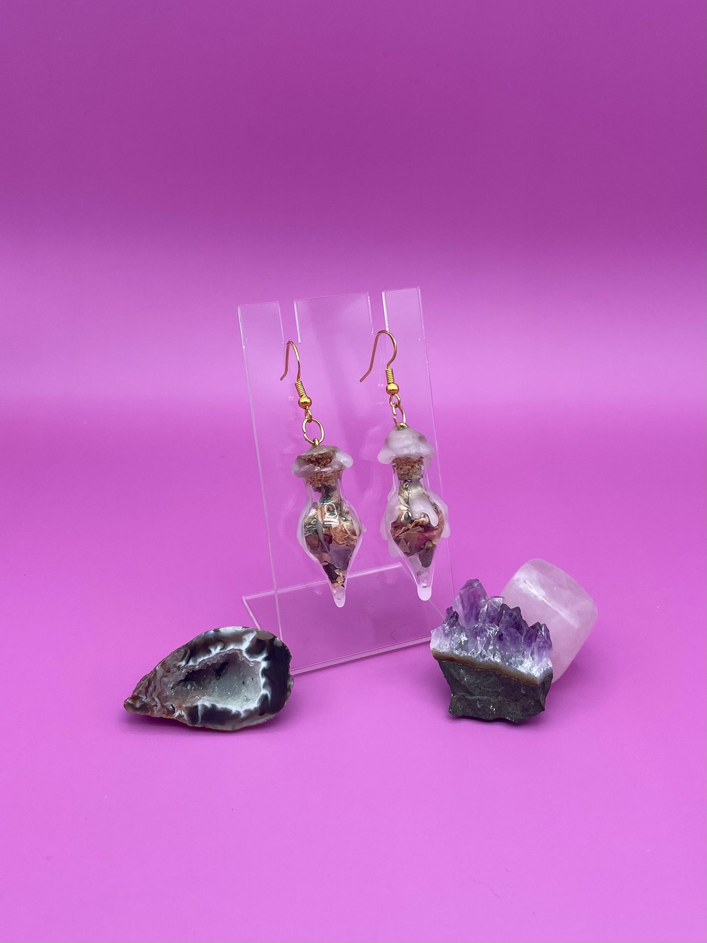 Love spell jar earrings on clear stand