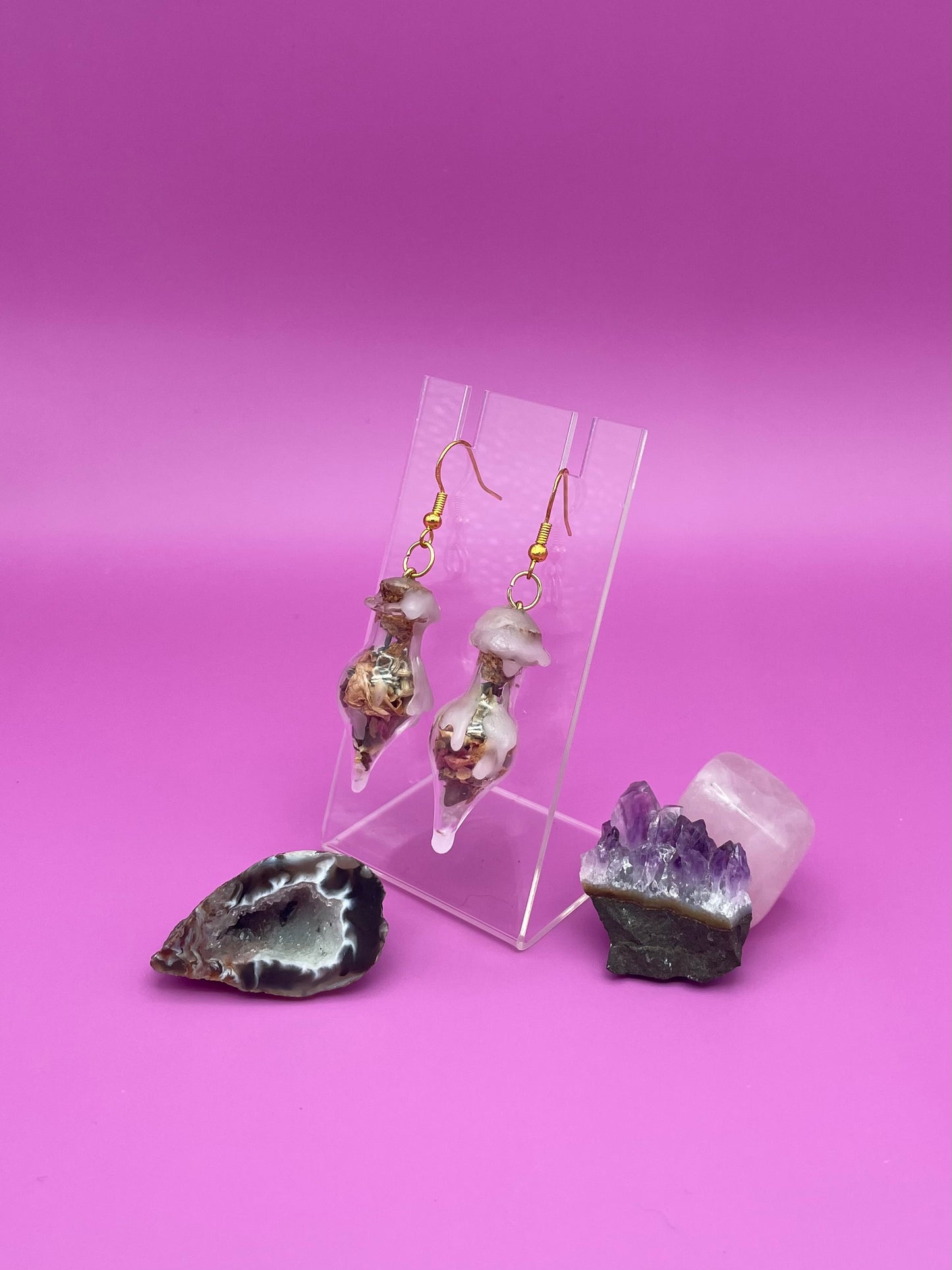 Love spell jar earrings on clear stand