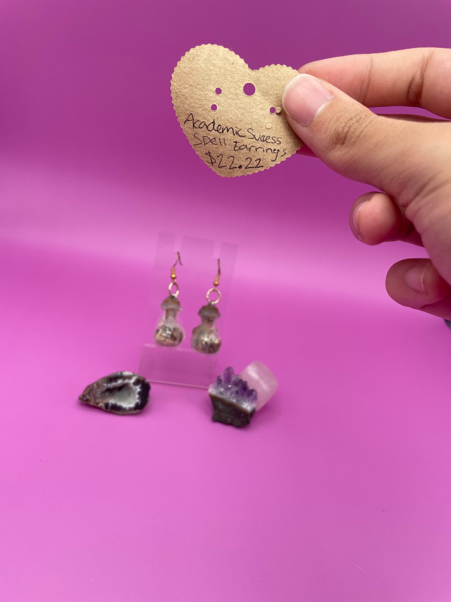 Academic success spell jar earrings on clear stand