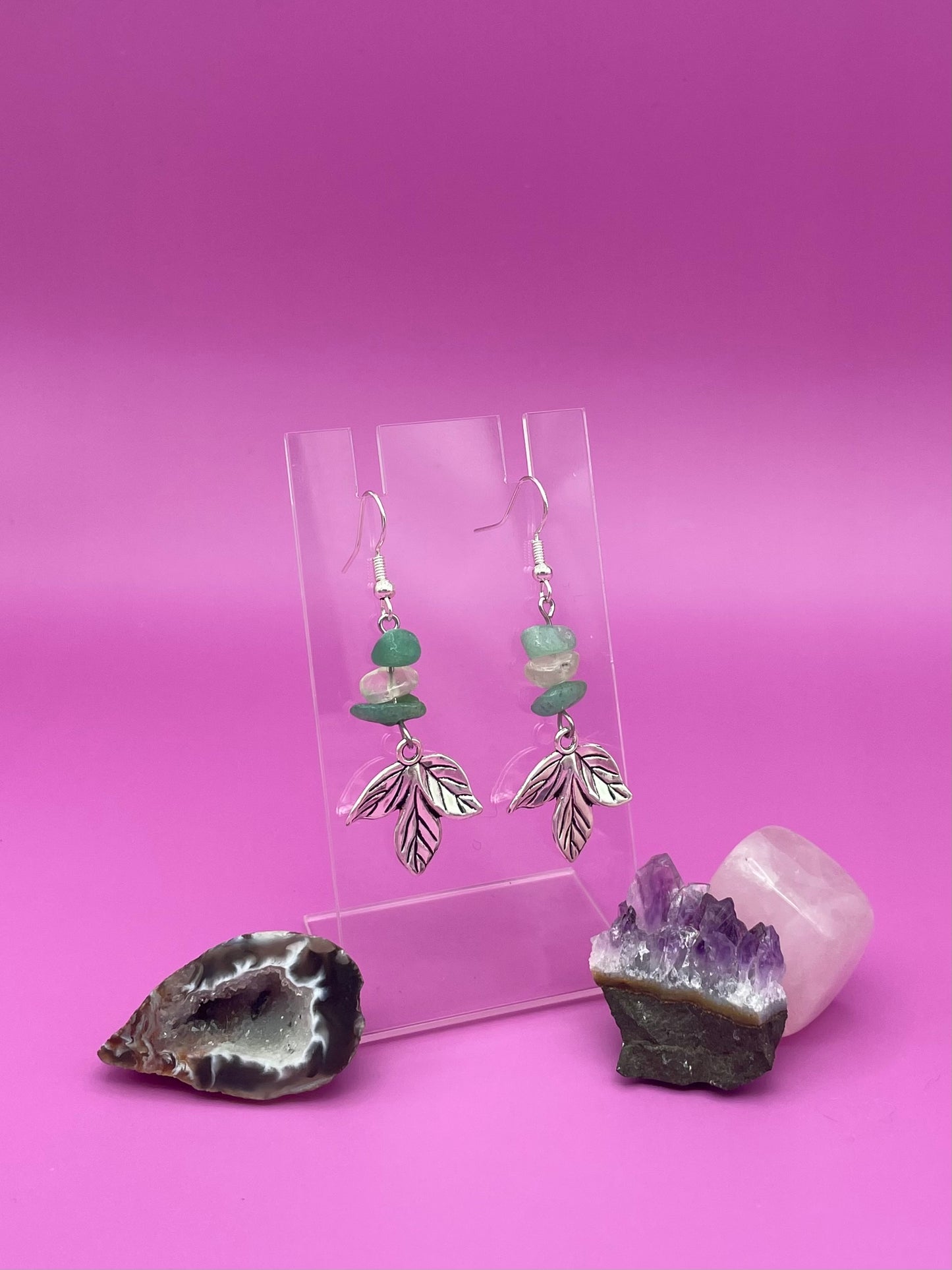 Silver leaf harm hanging with crystal chips above it, green aventurine and clear quartz in a pattern.