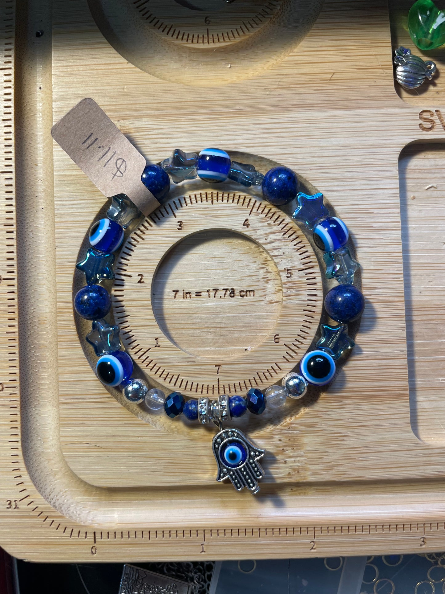 Bracelet with blue beads and Hamsa hand charm