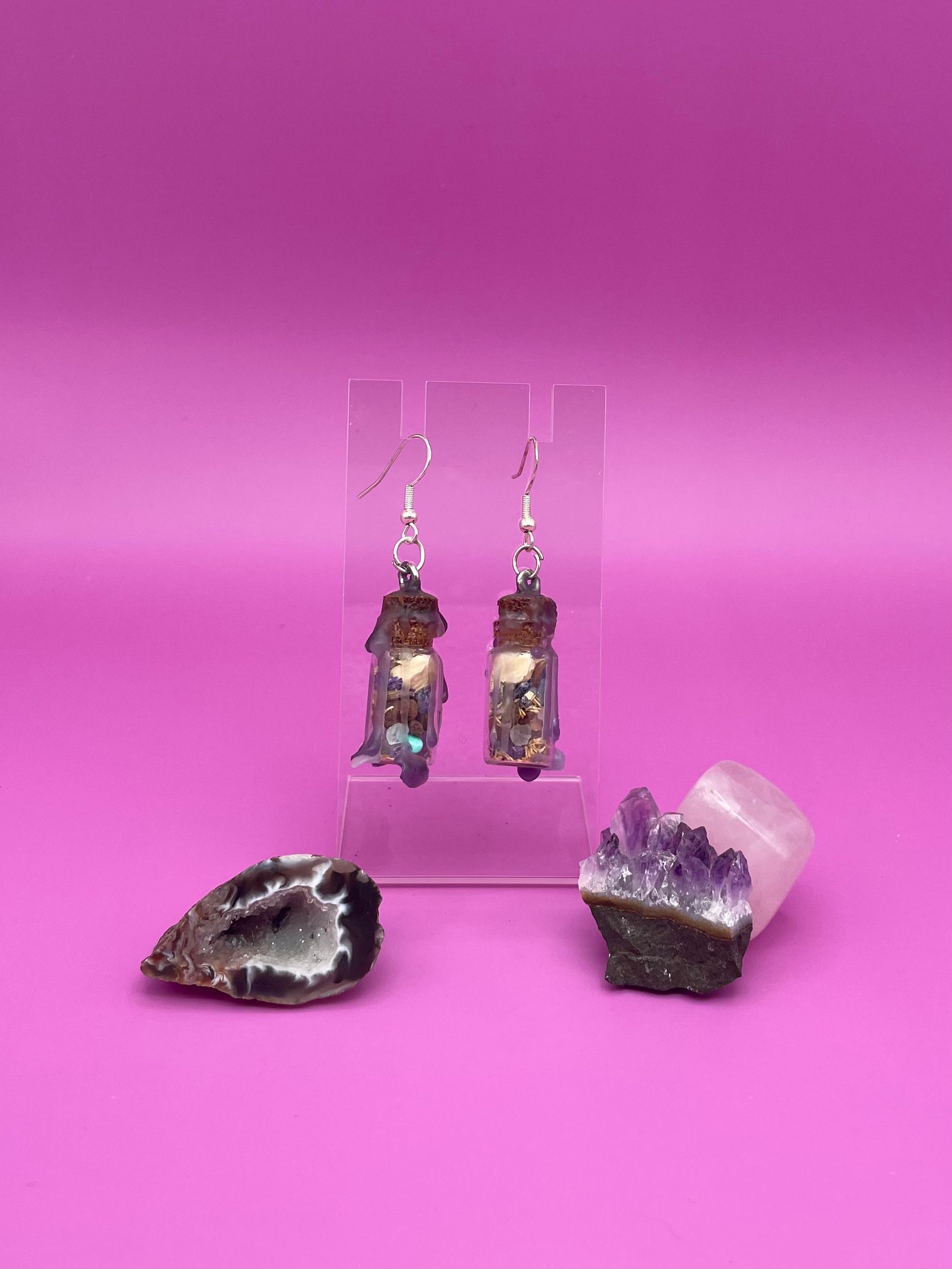 Peace spell jar earrings on clear stand 