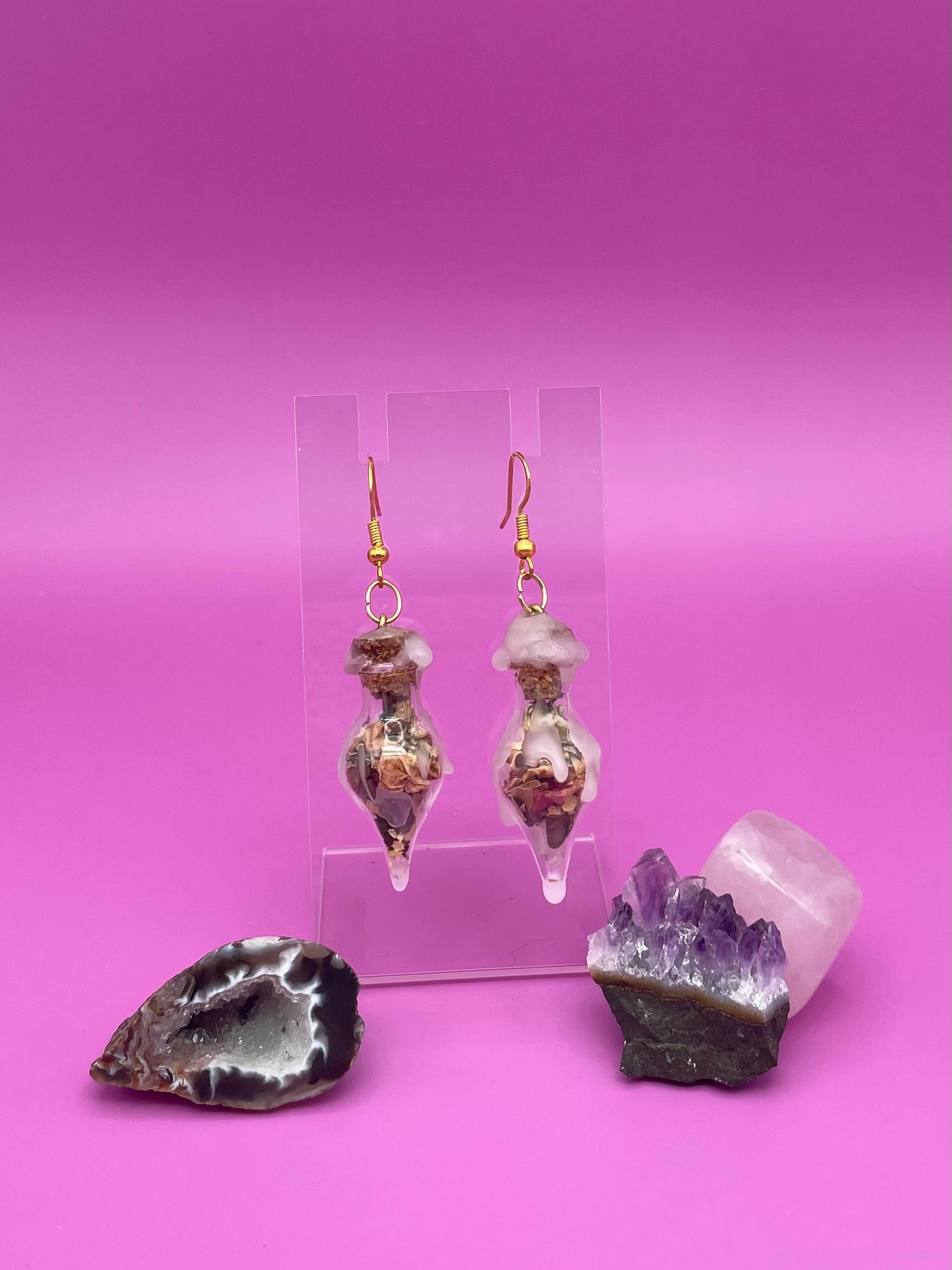 Love spell jar earrings on clear stand