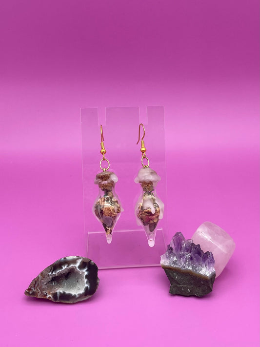 Love spell jar earrings on clear stand
