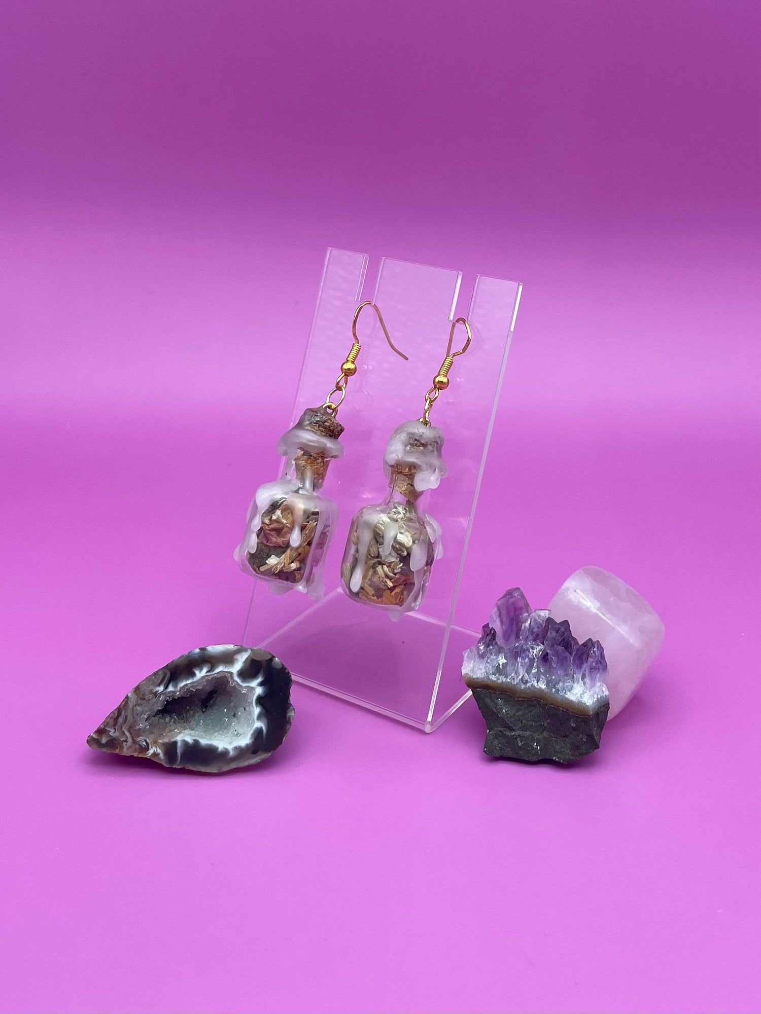 Love spell jar earrings on clear stand