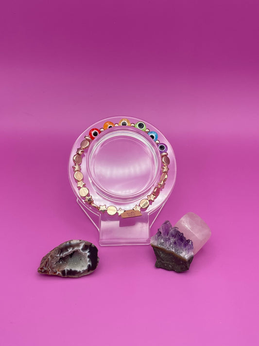 Rose Gold and rainbow evil eye bracelet on clear stand