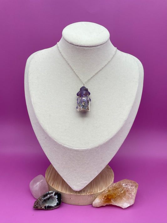 Peace spell jar Necklace sealed with purple wax on a white mannequin bust against a purple background